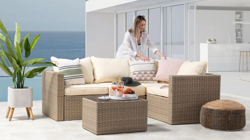 A lady standing beside modern patio furniture.