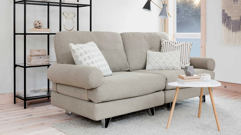 A large light coloured multifunctional two seater couch.