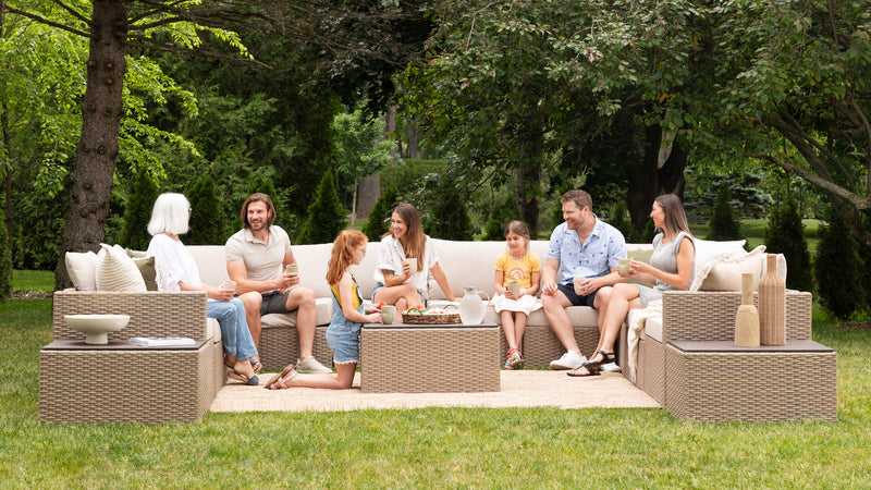 A group of friends sitting outside on their patio furniture.